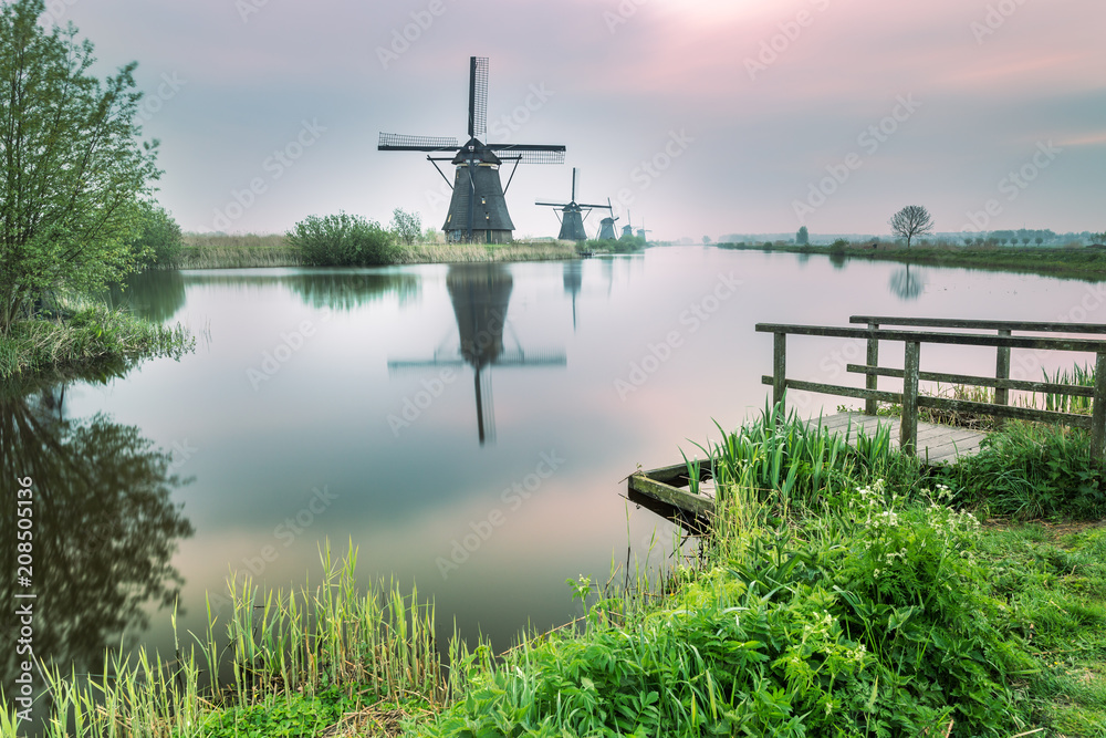Windmill reflected in the canal Kinderdijk Rotterdam South Holland Netherland Europe