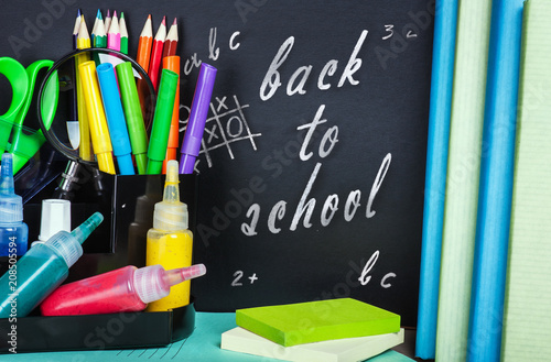 Wallpaper Mural school supplies and textbooks on black school chalkboard. Empty space to use for your text Torontodigital.ca