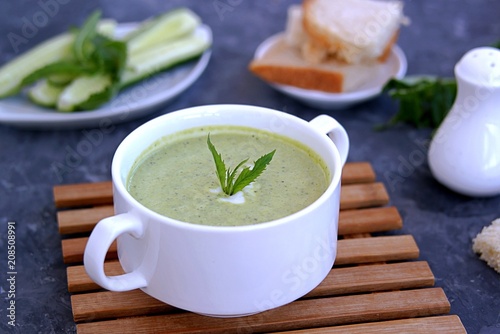 Summer cold yoghurt soup with fresh cucumber, green peas and mint 