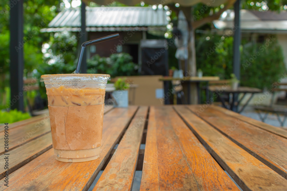 Iced coffee on a wooden table in the garden. Iced coffee on a wooden table in the garden.