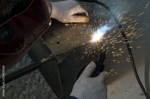 welder in the workplace, a lot of sparks and fire