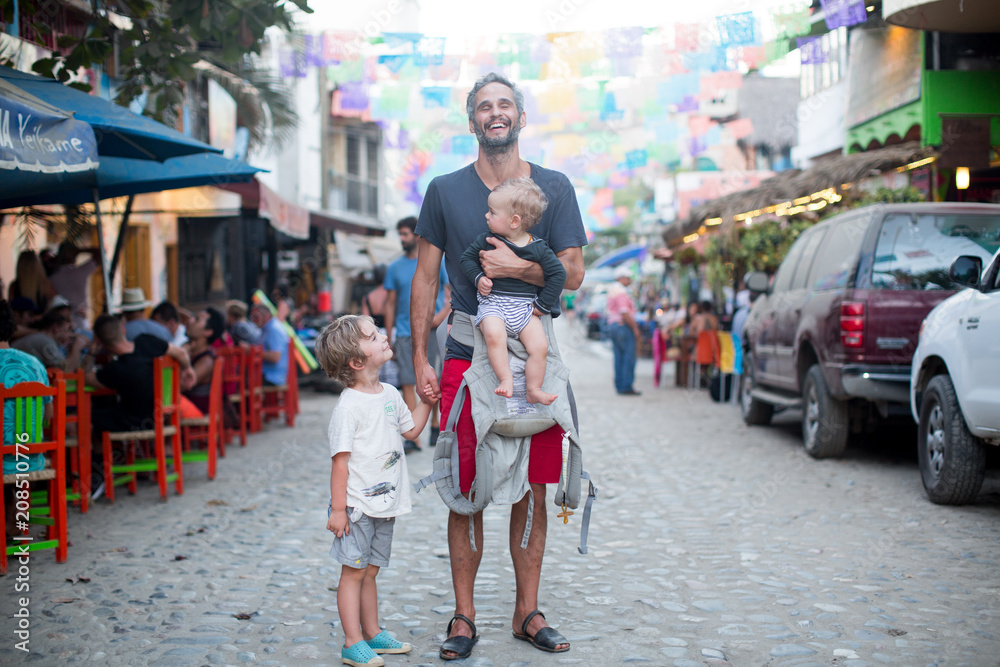 Obraz premium Happy Family Smiling in Street on Vacation in Mexico in Summer