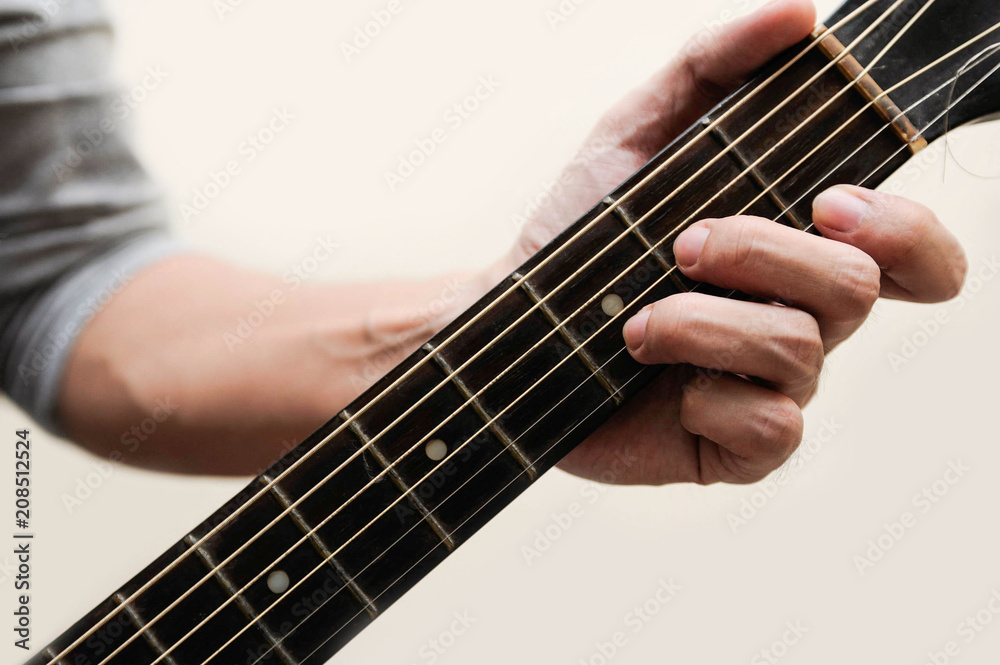 Guitar chords,Selective focus,Guitarist,The musicians are catching the guitar chords is D minor chord on white background Guitar chords,Selective focus,Guitarist,The musicians are catching the guitar chords is D minor chord on white background