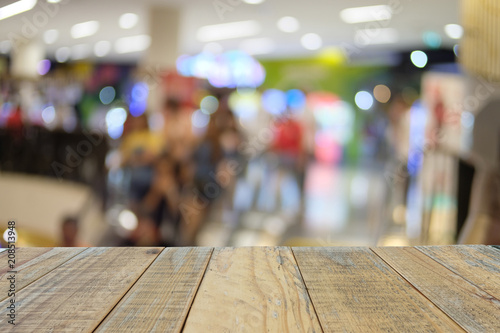 Empty wooden table on fron blurred shopping mall background, used for templated and presentation product