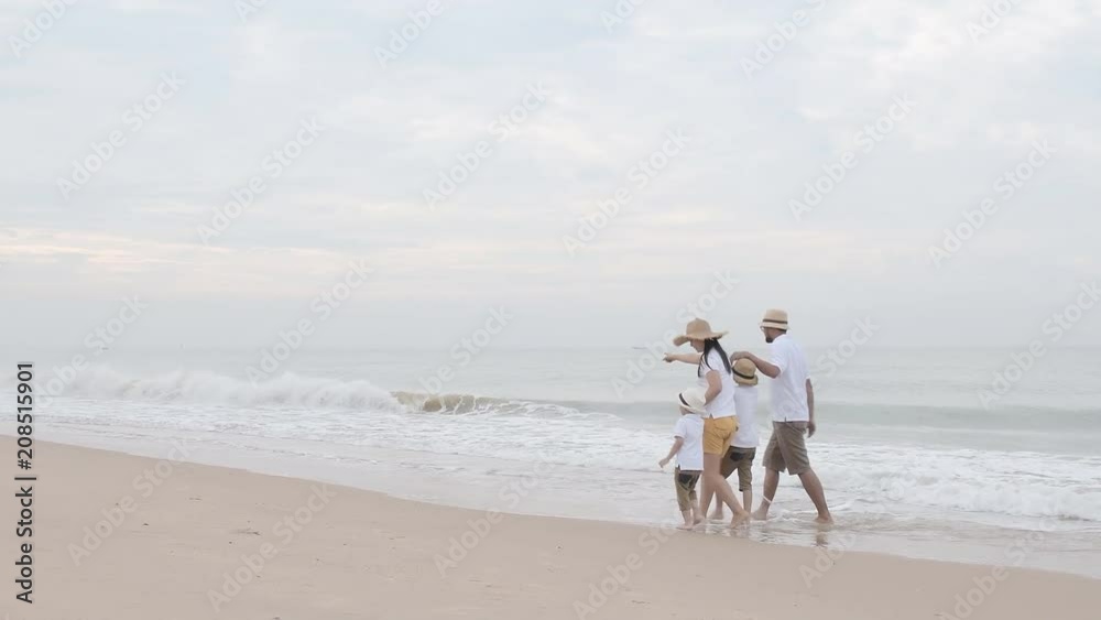 happy family with two kids on the beach, Happy family on sea beach at resort happy family with two kids on the beach, Happy family on sea beach at resort