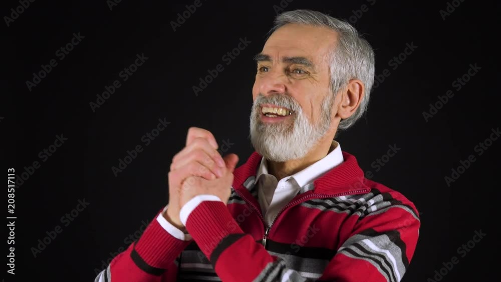 An elderly man celebrates - black screen studio