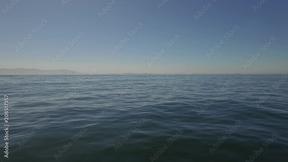 Tranquil ocean shot with city scape in background. Tranquil ocean shot with city scape in background.