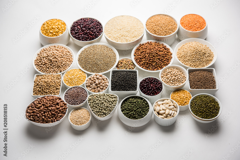 Uncooked pulses,grains and seeds in White bowls over white background. selective focus Uncooked pulses,grains and seeds in White bowls over white background. selective focus
