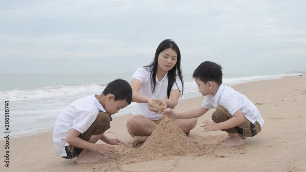 happy family with two kids on the beach, Happy family on sea beach at resort happy family with two kids on the beach, Happy family on sea beach at resort