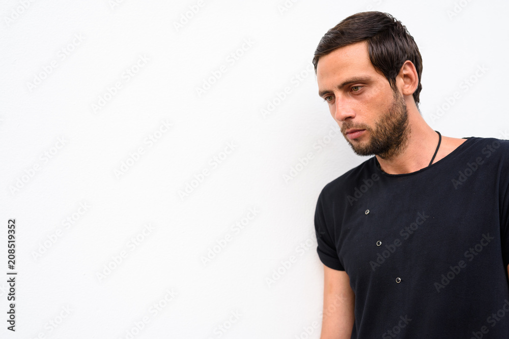 Handsome man wearing black shirt against white background Handsome man wearing black shirt against white background