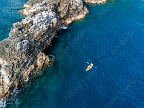 Ocean Kayak above SCUBA divers on a tropical coral reef