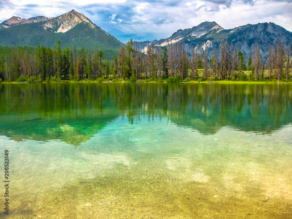Fototapeta premium Spectacular landscape of Sawtooth National Forest which is reflected in Alice Lake, heart of Idaho, United States.