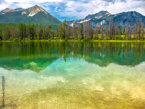 Spectacular landscape of Sawtooth National Forest which is reflected in Alice Lake, heart of Idaho, United States. photo