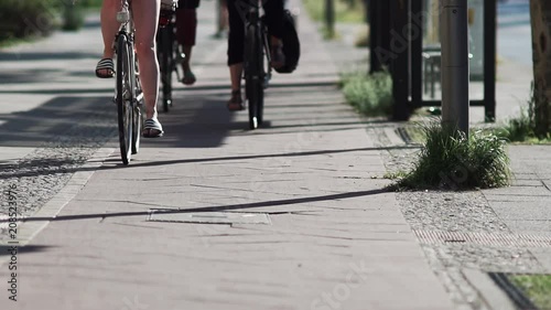 Female Cyclists In The City. Slow Motion Shot Of Female Cyclists Riding On The Bicycle Lane In Berlin.