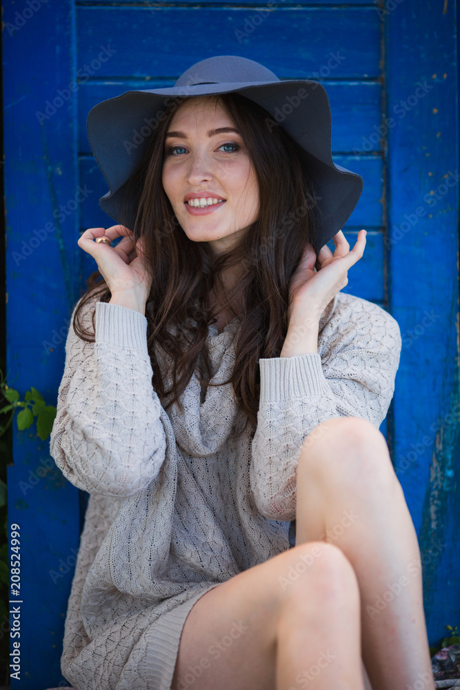 Fototapeta premium Portrait of beautiful young woman with makeup in black hat 