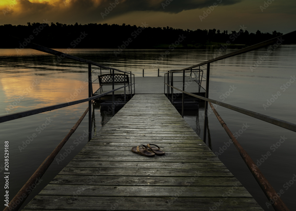 Sandals on the dock at sunset