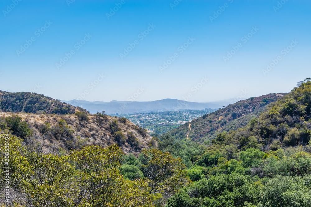 Suburbs of Southern California in the distance with view of mountains and smog cover