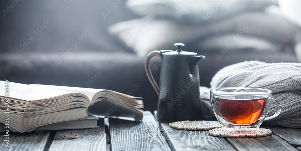 still life book and a cup of tea in the living room - obrazy, fototapety, plakaty 