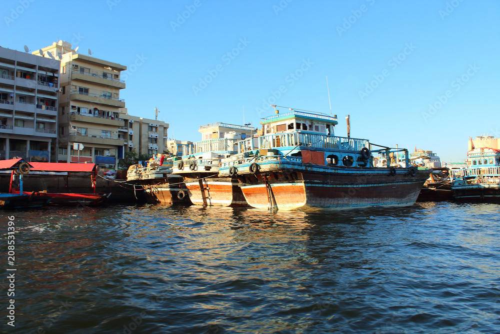 Trading wooden boats in the port. Merchant ships on the Creek Canal. Background. Landscape. Dubai Creek, March, 2018.