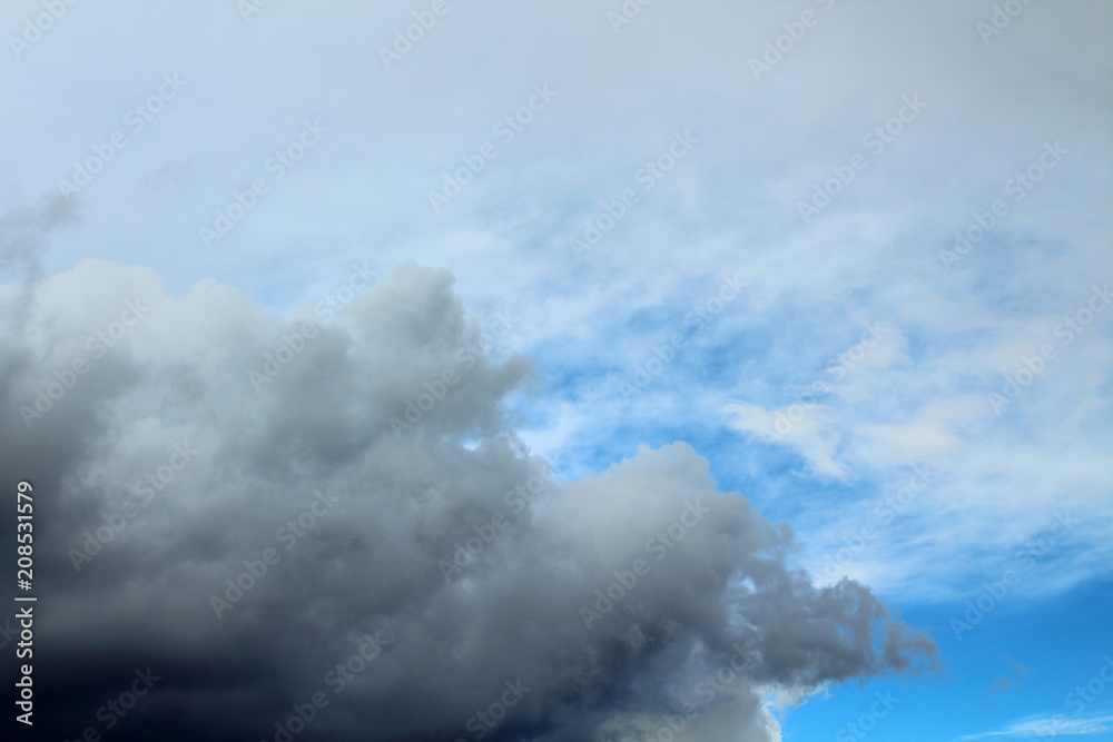 The blue sky and dark storm clouds. Background. Landscape.