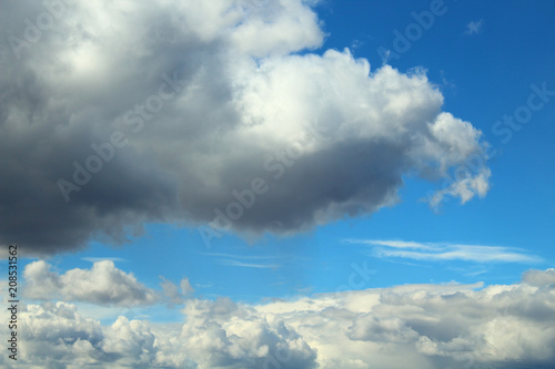 Beautiful blue sky and fluffy white gray clouds. Background. Landscape. Natural appearance.