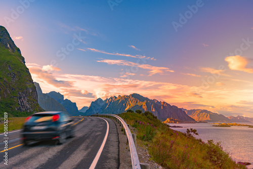 Car on road in Norway, Europe. Sunset travel photo