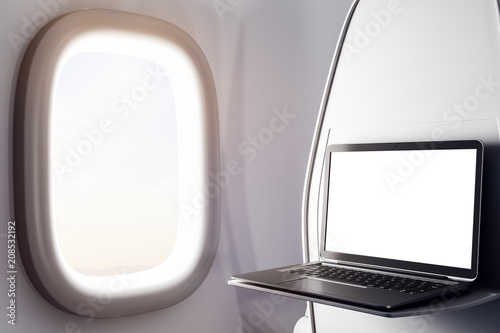 Empty laptop in airplane photo