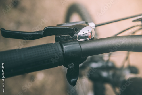 Close up bicycle speed selector. Close-up of handlebars with brake lever.