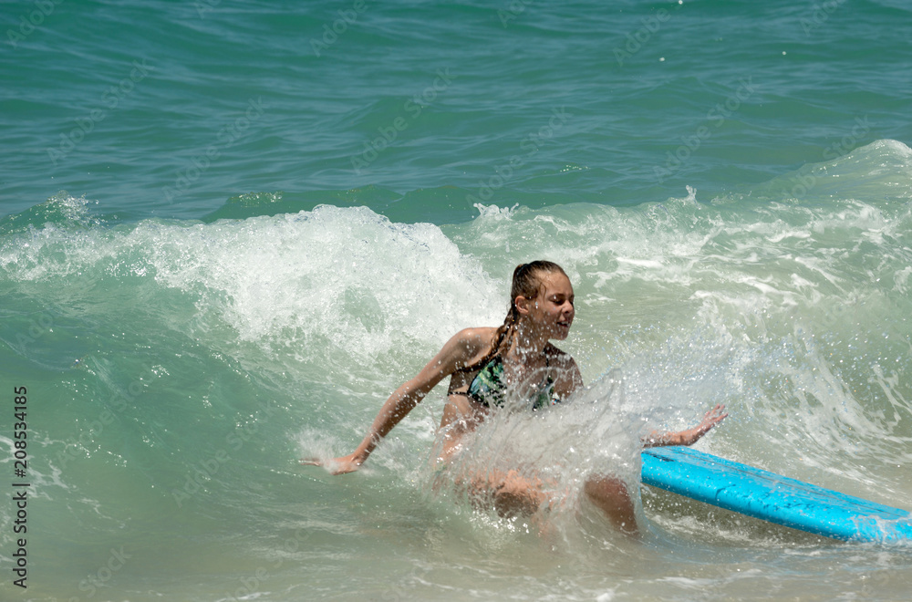 Surfer girl in a wave
