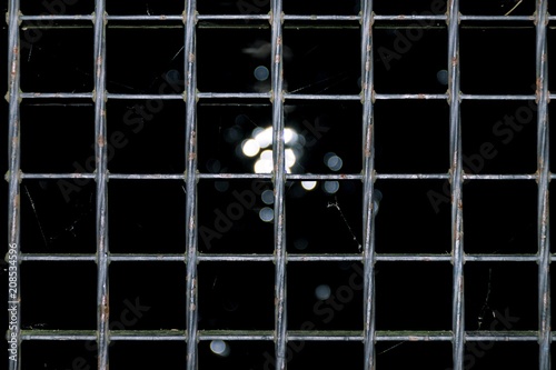 The texture of the lattice of the silver floor, the light passes through the lattice, the background of the metal lattice photo