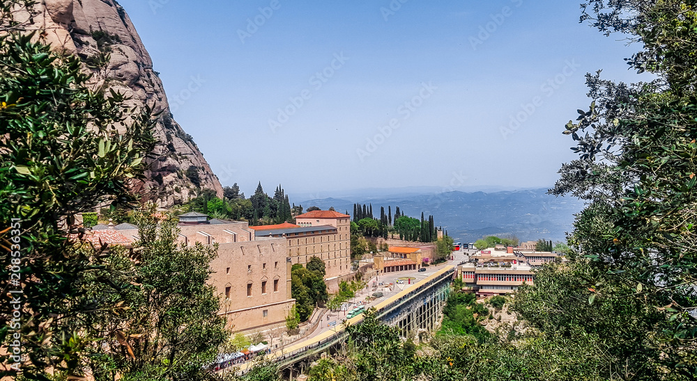 Obraz premium Benedictine abbey Santa Maria de Montserrat on a multi-peaked rocky range Montserrat. Barcelona, Spain.