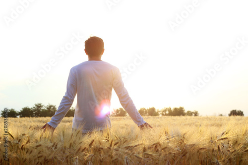 man in the field on a sunset background