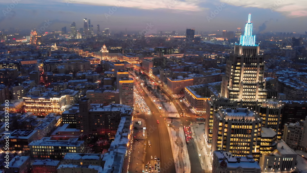 Fototapeta premium Aerial shooting of Moscow Garden Ring in the evening. City lights in the dusk. Business center 