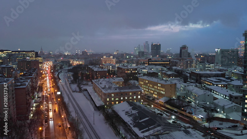 Moscow night aerial shot along railways  late evening Russian capital cityscape street view.