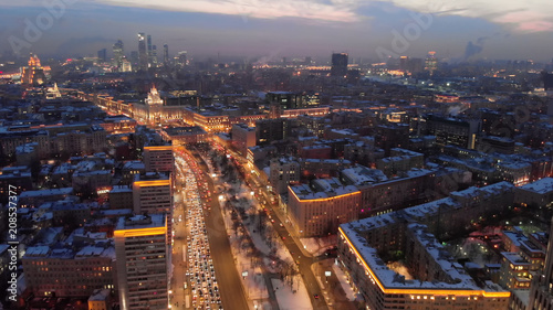Aerial shooting of Moscow Garden Ring in the evening. City lights in the dusk. Business center  Armory  tower at sunset.