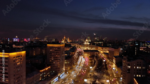Aerial shooting of Moscow Garden Ring at night. City lights and intensive traffic on the highway. Panoramic cityscape with illuminated buildings.