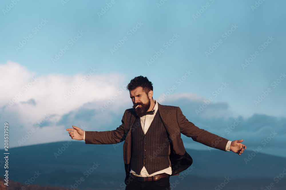 Smoker tourist man on mountain top in summer Smoker tourist man on mountain top in summer