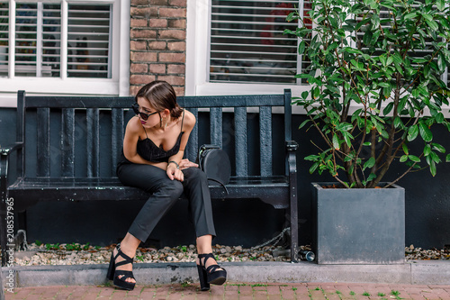 Photography portrait of a beautiful fashionable young girl in the streets of Amsterdam, the