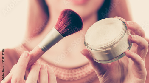 Woman holding make up brush