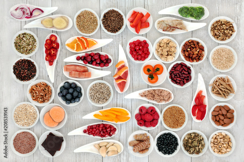 Health food for a healthy heart with fish, vegetables, fruit, nuts, seeds, pulses, spice & medicinal herbs. Super food concept. High in omega 3 fatty acid, smart carbs, antioxidants & minerals.