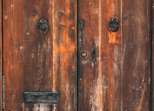 Texture of wooden brown old maltese door