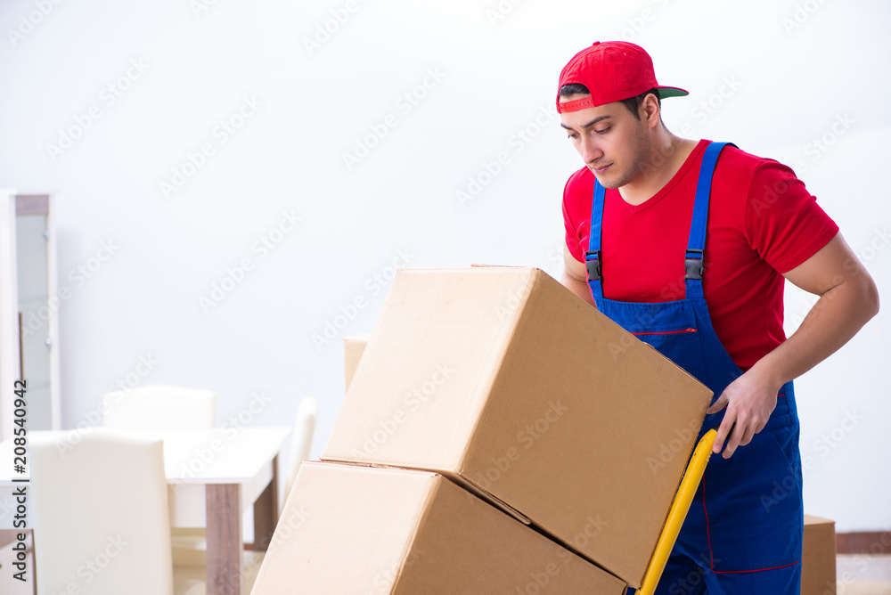 Contractor worker moving boxes during office move Contractor worker moving boxes during office move