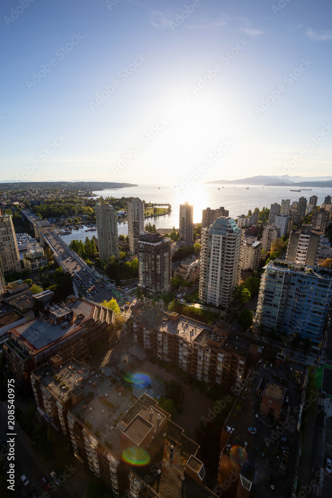 Obraz premium Striking Aerial View of the Modern City during a vibrant sunset. Taken in Downtown Vancouver, British Columbia, Canada.