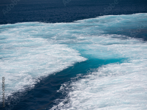 Close up of the sea that is foaming due to the ship's engine
