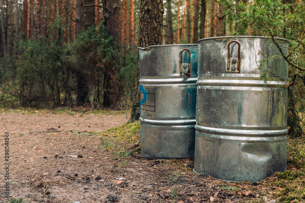 Garbage in big metal containers in nature, forest, at river as a concept of spring cleaning. Protecting ecology. Garbage in big metal containers in nature, forest, at river as a concept of spring cleaning. Protecting ecology.