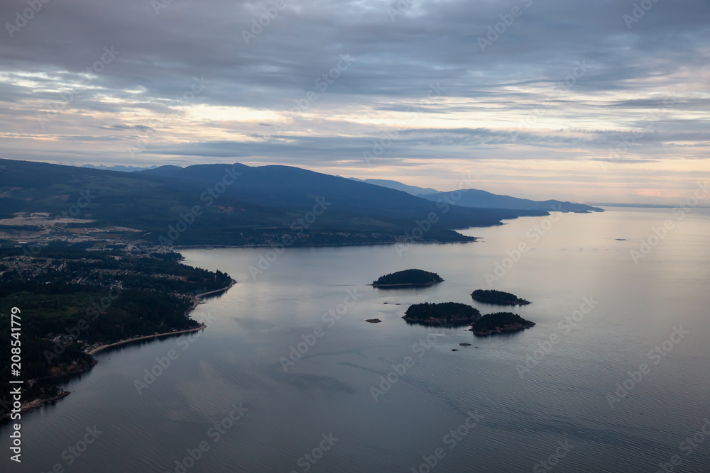 Aerial view of Sunshine Coast during a vibrant cloudy sunset. Located Northwest of Vancouver, British Columbia, Canada.