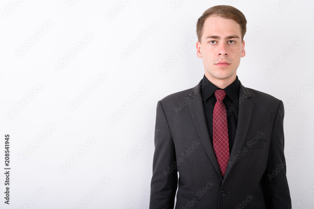 Young handsome businessman wearing suit against white background Young handsome businessman wearing suit against white background