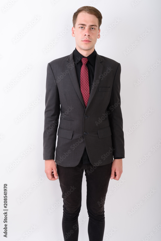 Young handsome businessman wearing suit against white background