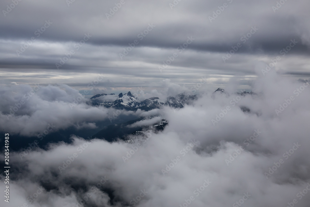 Aerial view of the striking Canadian Mountain Landscape covered in clouds. Taken North of Vancouver, British Columbia, Canada.