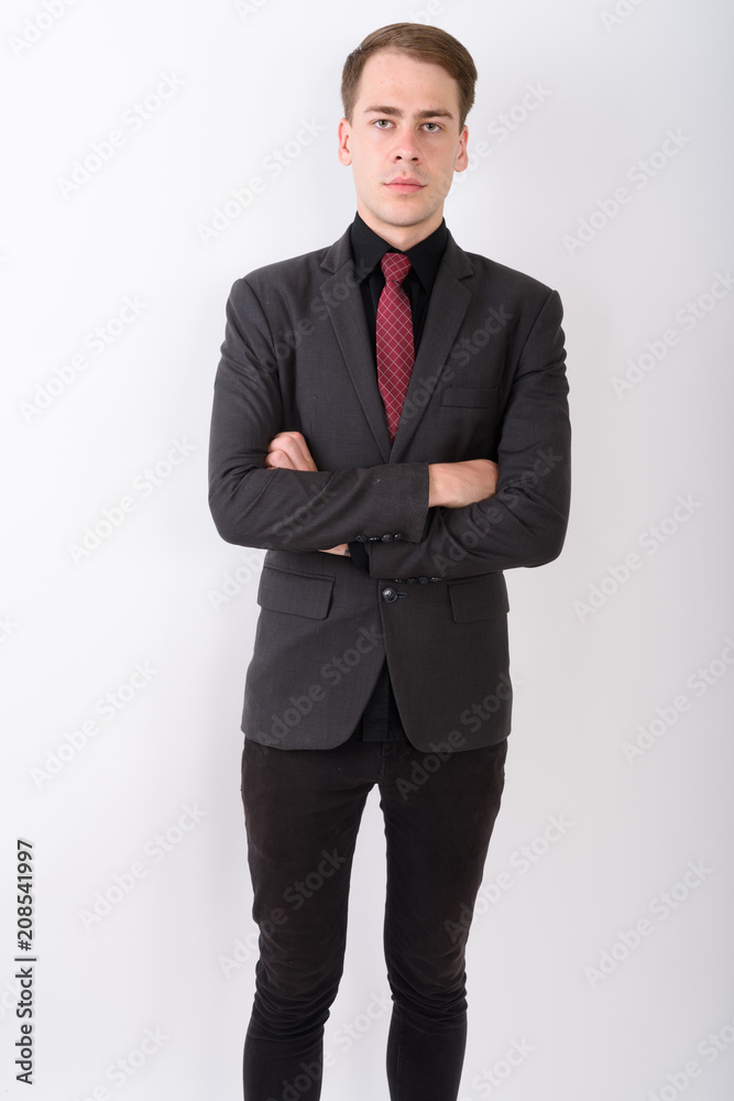 Young handsome businessman wearing suit against white background Young handsome businessman wearing suit against white background